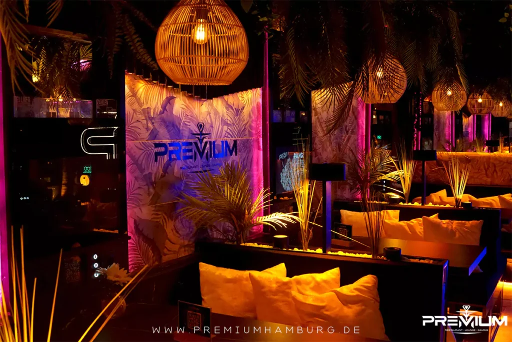 A luxurious Shisha lounge with marble tables, lush palm decor, and warm ambient lighting, representing one of the best shisha bars in Hamburg